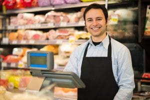 Portrait of a smiling shopkeeper in a grocery store