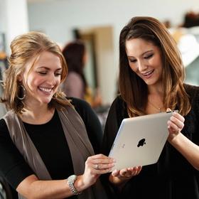 Two Women holding iPad