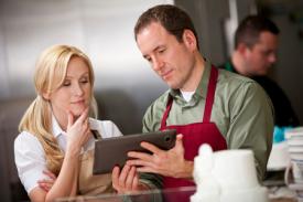 Man and Woman looking at iPad