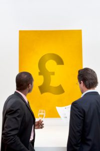 Male executive looking at Pound sign over white background