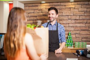 Male cashier being friendly to a customer