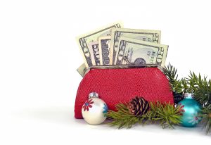 money in purse with Christmas ornaments