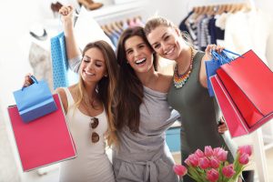 Picture showing group of happy friends shopping in store