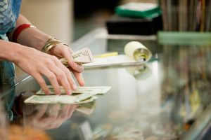 Shop keeper counting money in shop