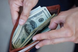 Man holding wallet with cash