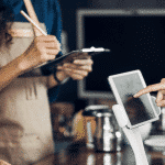 cafe employees using an iPad to complete sales transaction
